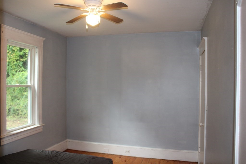 321 Easthampton Road Northampton, MA 01062 - Photo 11 of 15 an empty room with a window and a fan