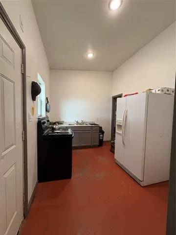 a view of patio with table and chairs under an umbrella