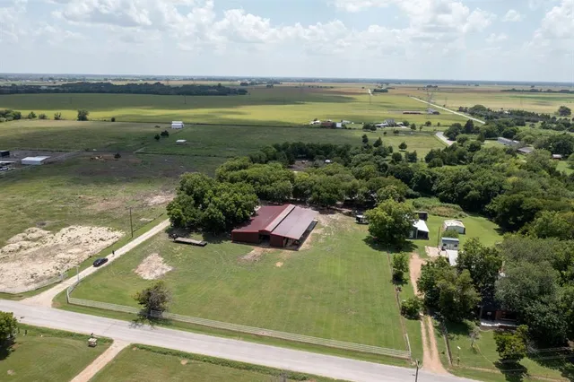 an aerial view of a house with a yard and outdoor space