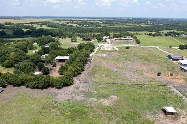 an aerial view of residential houses with outdoor space and river
