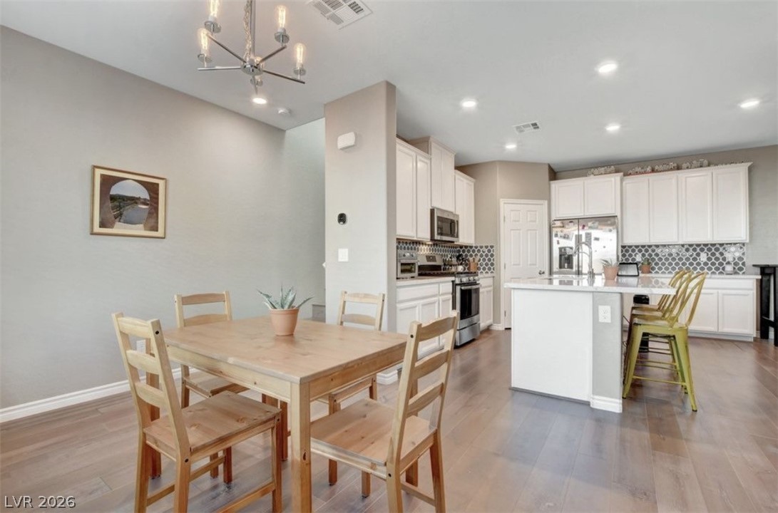 6920 Fossil Rim Street North Las Vegas, NV 89084 - Photo 4 of 9 Hardwood floors flow through this open-concept kitchen and dining area.