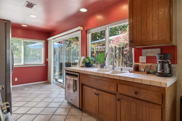 a kitchen with a sink window and cabinets