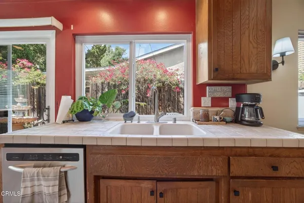 a kitchen with granite countertop a sink and a potted plant