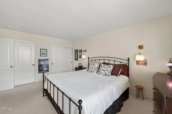 a bedroom with a bed and a lamp with the table