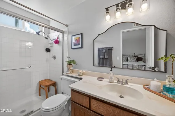 a bathroom with a sink vanity mirror and toilet