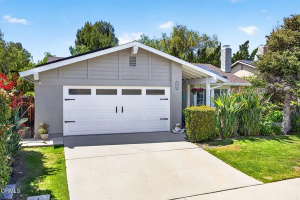a view of a house with a yard and garage