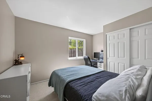 a bedroom with two beds and a window