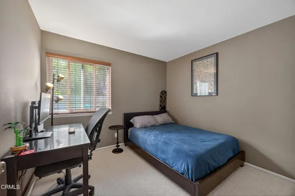 a bedroom with a bed and a table in it