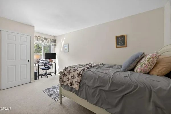 a bedroom with a bed and chair