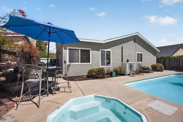 a view of a house with swimming pool and sitting area
