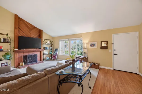 a living room with furniture a flat screen tv and a fireplace