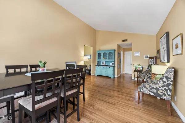 a view of a dining room with furniture and wooden floor