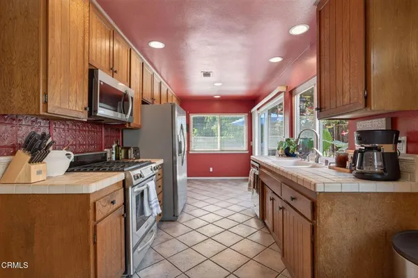 a kitchen with stainless steel appliances granite countertop a sink stove and cabinets