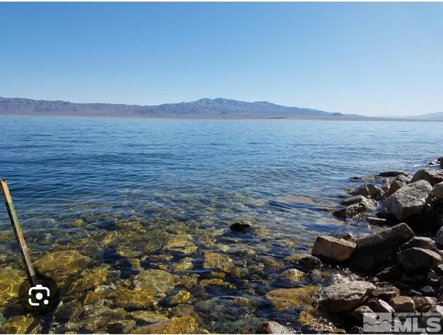 a view of a large mountain with a mountain in the background