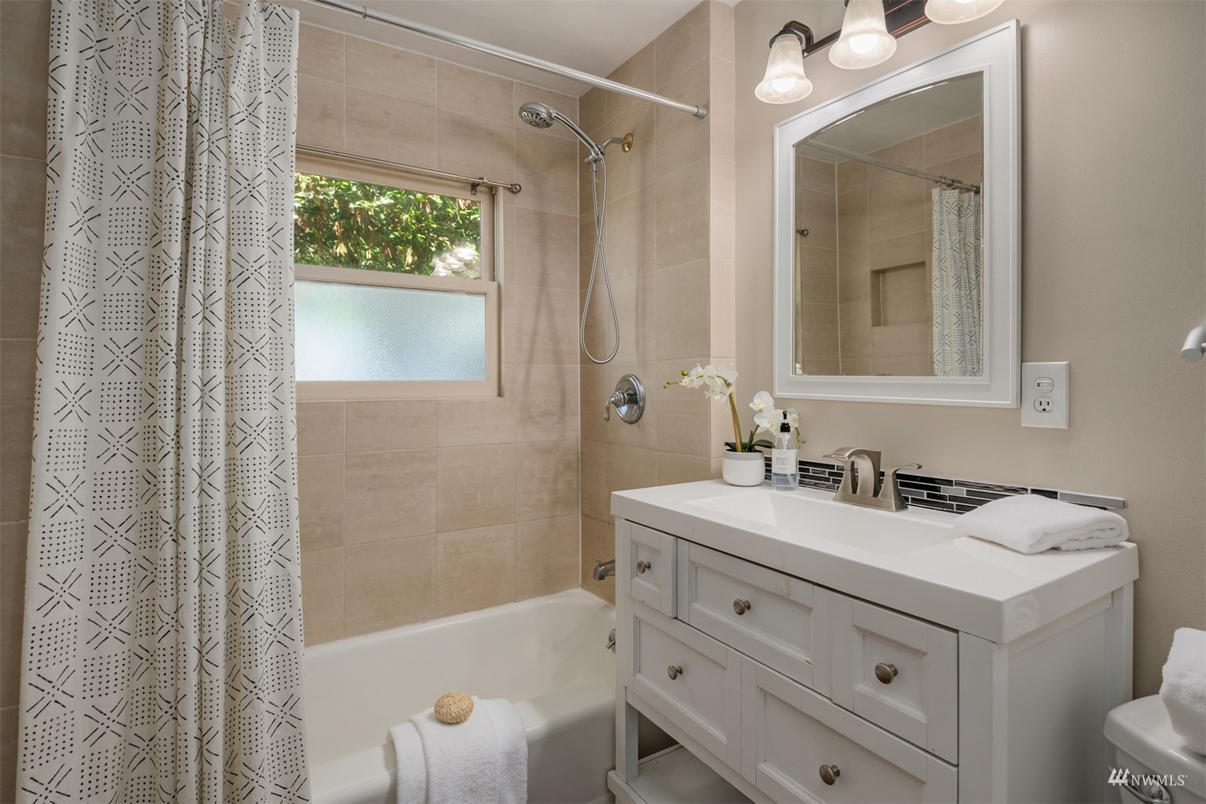 3912 Southwest Holden Street Seattle, WA 98136 - Photo 13 of 27 a bathroom with a sink a toilet and shower