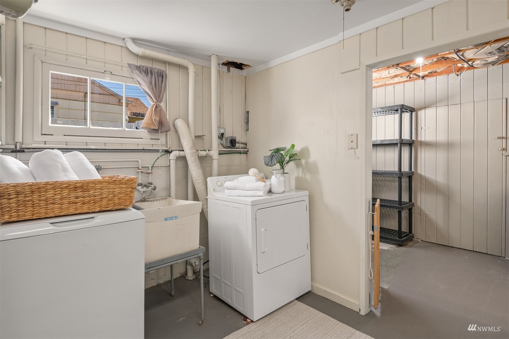 3912 Southwest Holden Street Seattle, WA 98136 - Photo 20 of 27 a room that has a washer and dryer with wooden floor
