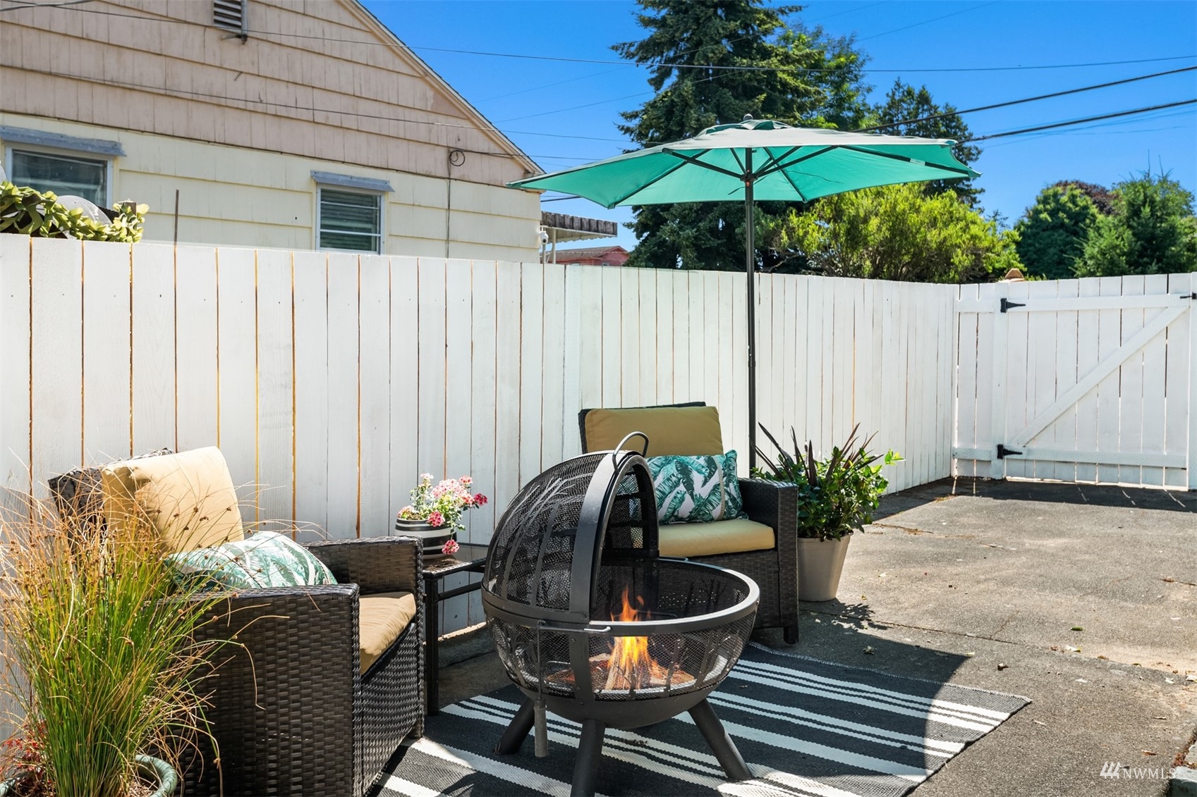 3912 Southwest Holden Street Seattle, WA 98136 - Photo 25 of 27 a backyard of a house with table and chairs