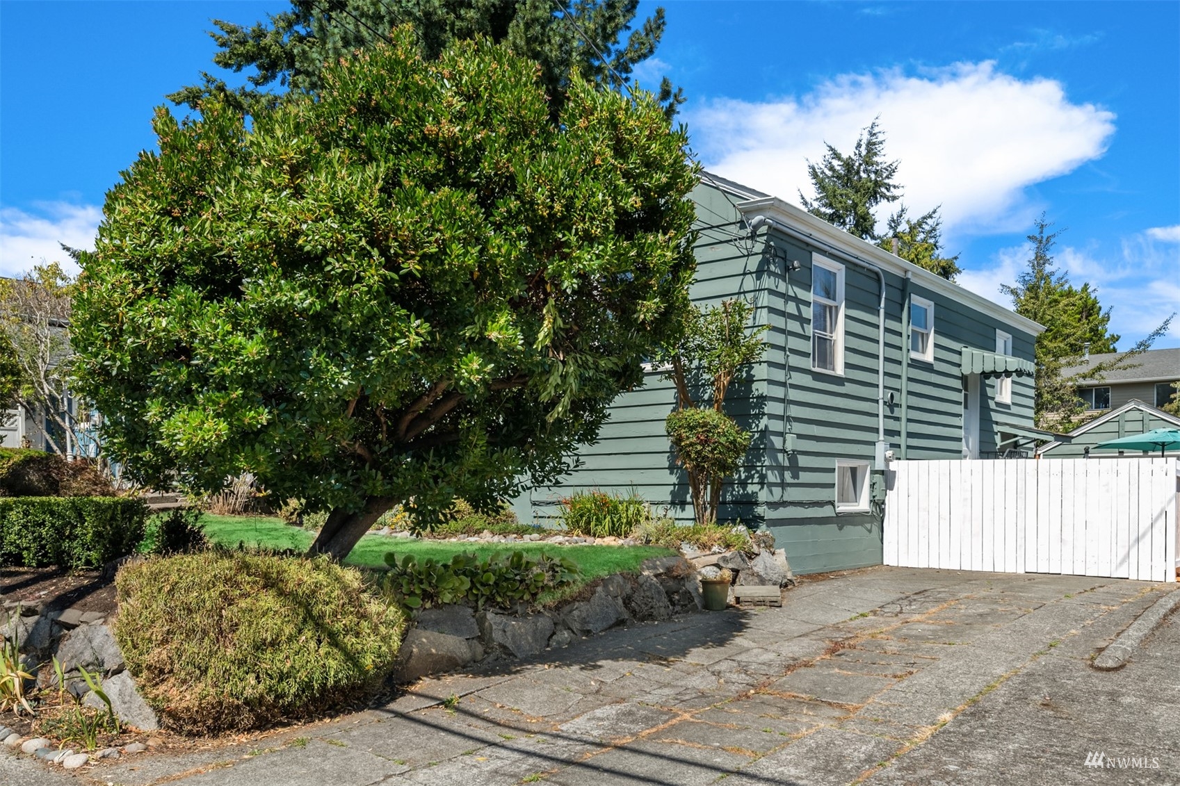 3912 Southwest Holden Street Seattle, WA 98136 - Photo 27 of 27 a side view of a house with a yard