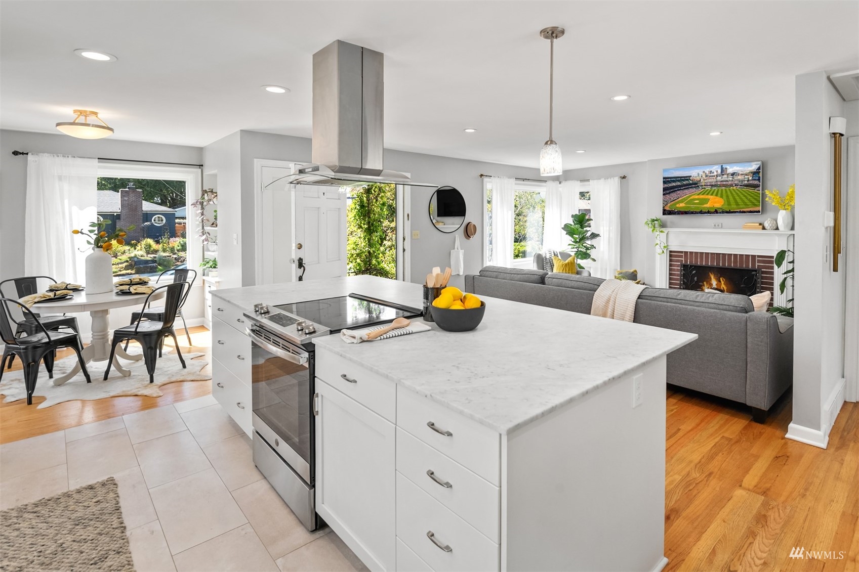 3912 Southwest Holden Street Seattle, WA 98136 - Photo 6 of 27 a kitchen with sink stove dining table and chairs