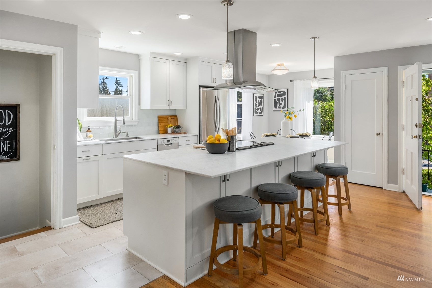 3912 Southwest Holden Street Seattle, WA 98136 - Photo 10 of 27 a kitchen with stainless steel appliances a dining table chairs and wooden floor