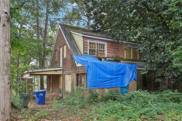 a front view of house with a garden