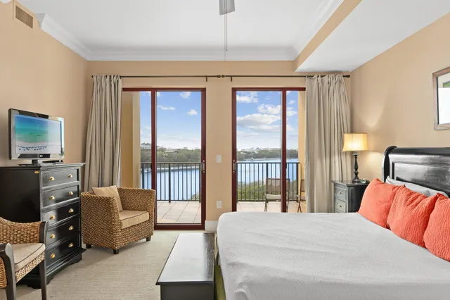 a bedroom with furniture and large window