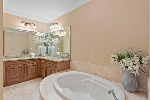 a bathroom with a bathtub sink and mirror