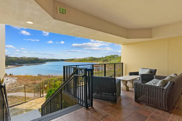 a view of a chairs and table in the balcony