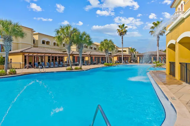 a view of a swimming pool with outdoor seating