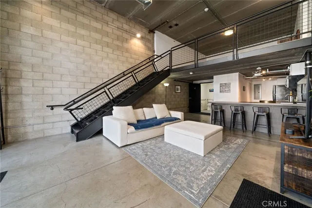 a living room with lots of furniture and a wooden floor