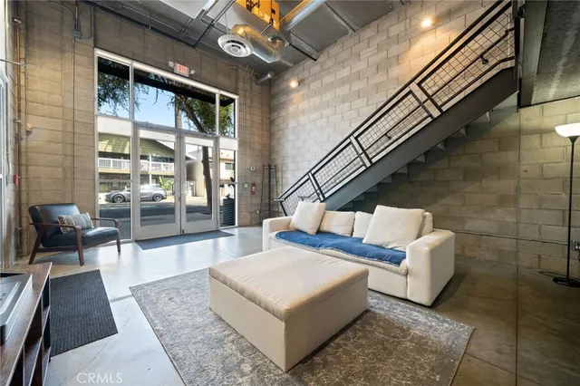 a living room with patio furniture and a large window