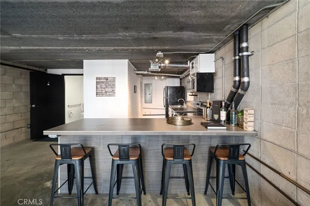 a kitchen with stainless steel appliances a table and chairs in it