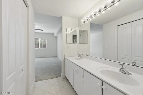 a bathroom with a double vanity sink and mirror