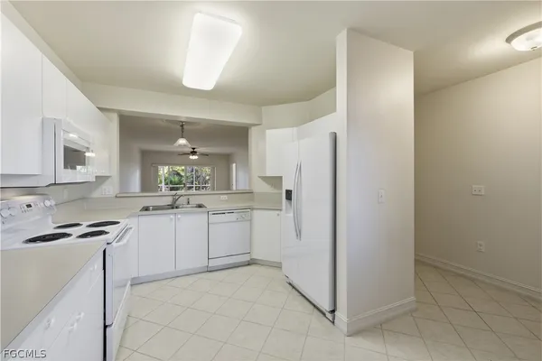 a kitchen with a refrigerator and a sink