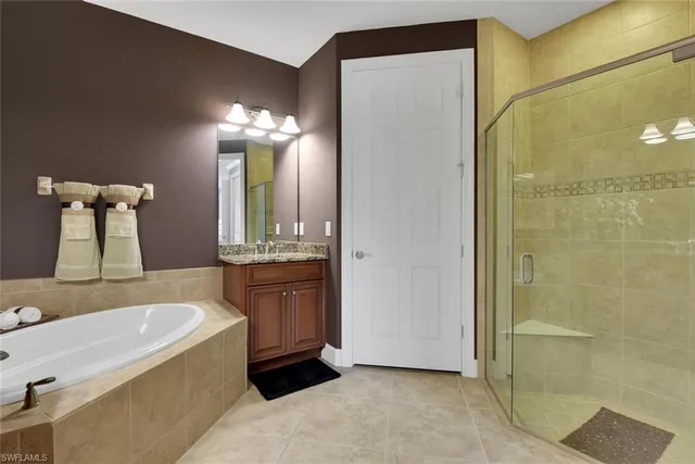 a bathroom with a tub sink and mirror