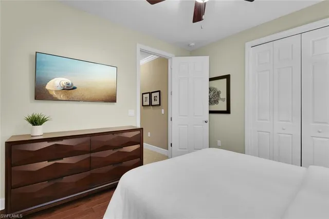 a bedroom with a bed and a painting on the wall