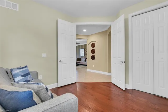 a living room with furniture and wooden floor