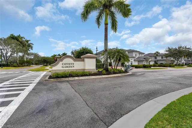 a front view of a house with a garden and trees