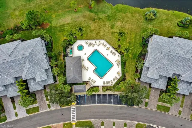 an aerial view of a house with swimming pool and garden
