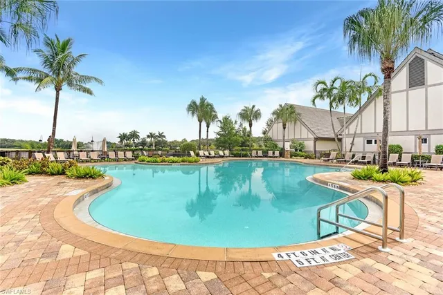 a view of a swimming pool with a lounge chair