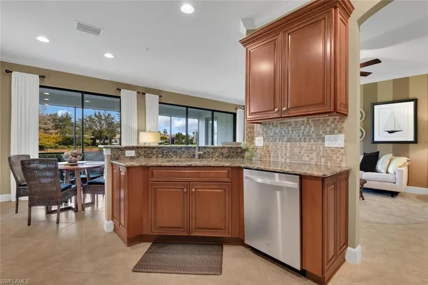 a kitchen with kitchen island granite countertop wooden cabinets and a granite counter tops