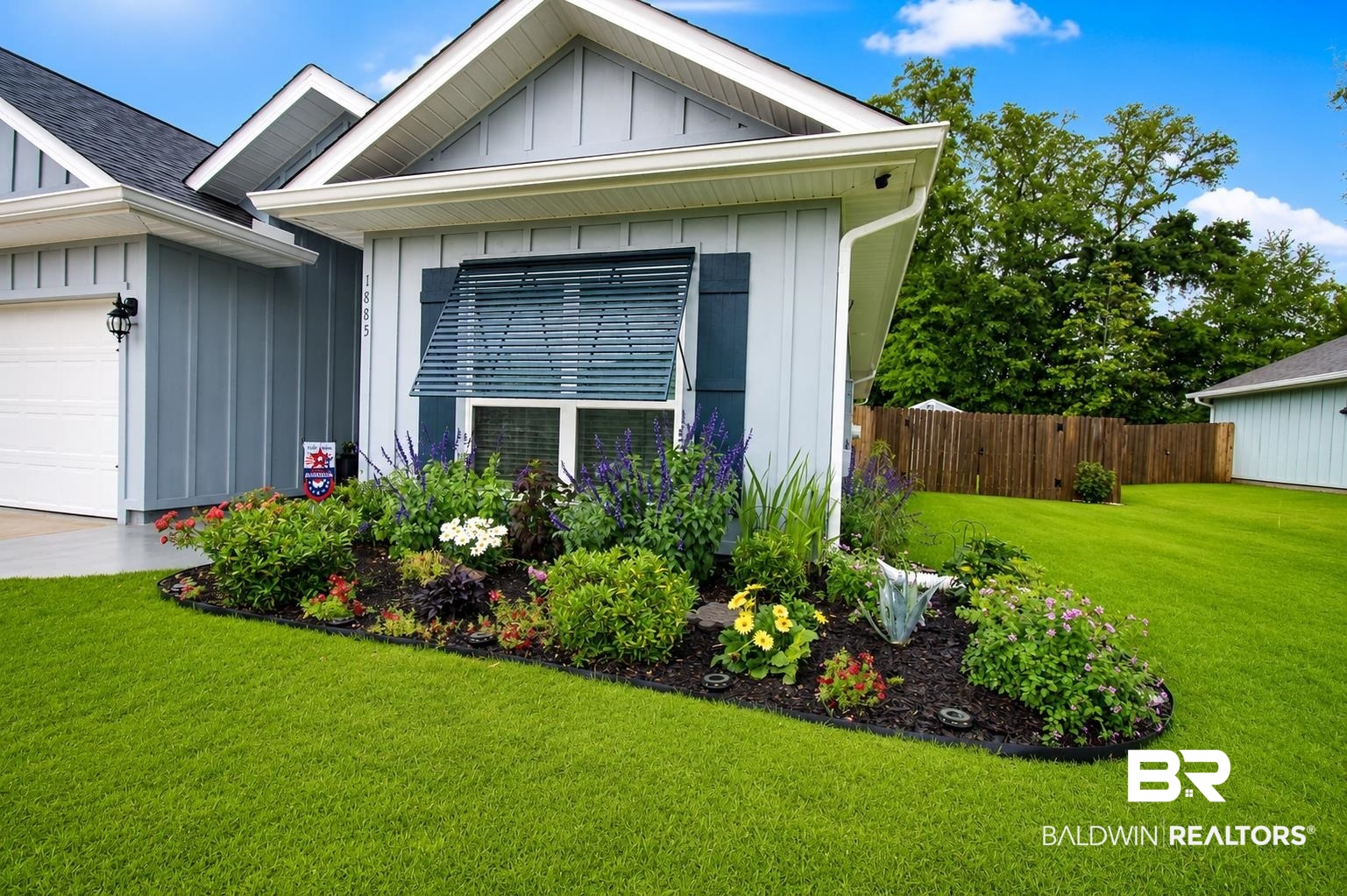 1885 Carly Street Foley, AL 36535 - Photo 36 of 40 Front exterior featuring light blue vertical siding, a dark asphalt shingle roof, and white soffit and fascia