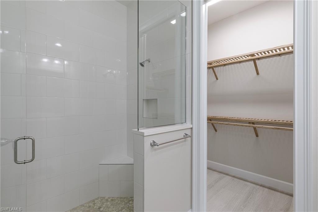 8909 Yucatan Court Naples, FL 34113 - Photo 10 of 36 a bathroom with a glass shower door