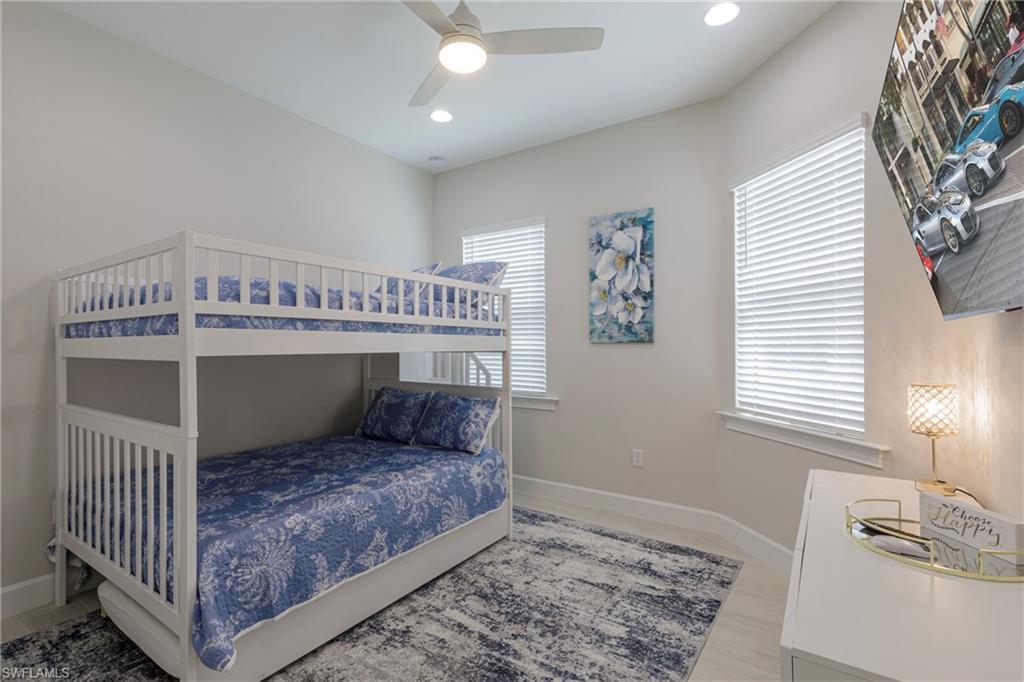 8909 Yucatan Court Naples, FL 34113 - Photo 13 of 36 a bedroom with a bed and a window