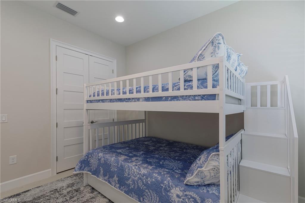 8909 Yucatan Court Naples, FL 34113 - Photo 14 of 36 a bedroom with a bed and a window