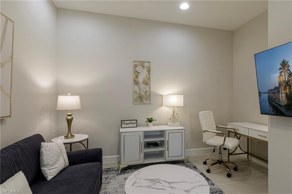 8909 Yucatan Court Naples, FL 34113 - Photo 15 of 36 a workspace with furniture and a lamp