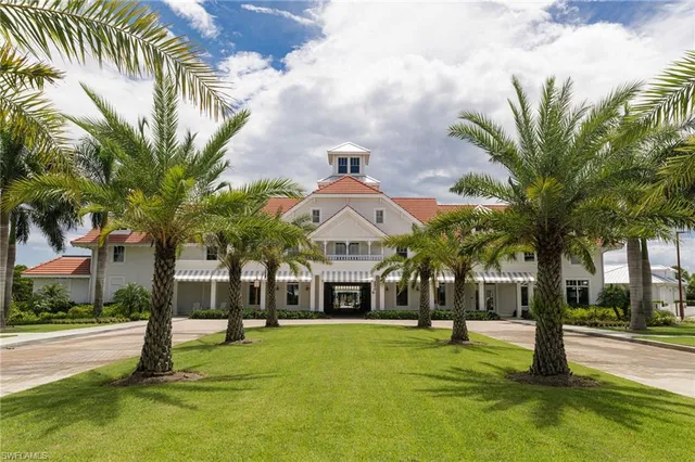 a view of swimming pool with a yard and palm trees