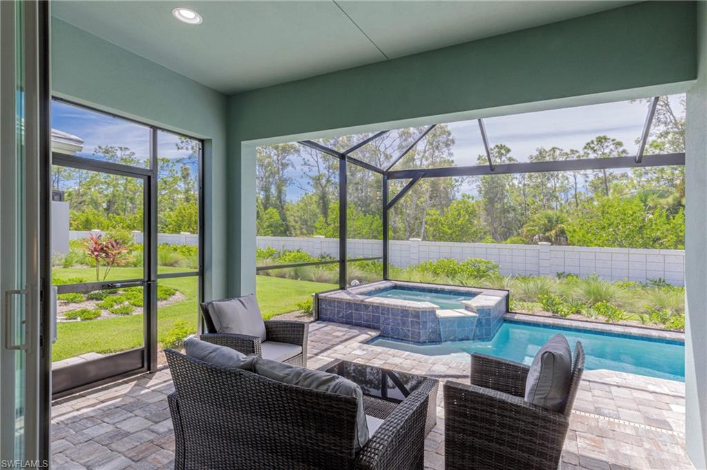 8909 Yucatan Court Naples, FL 34113 - Photo 4 of 36 a living room with furniture and a large window