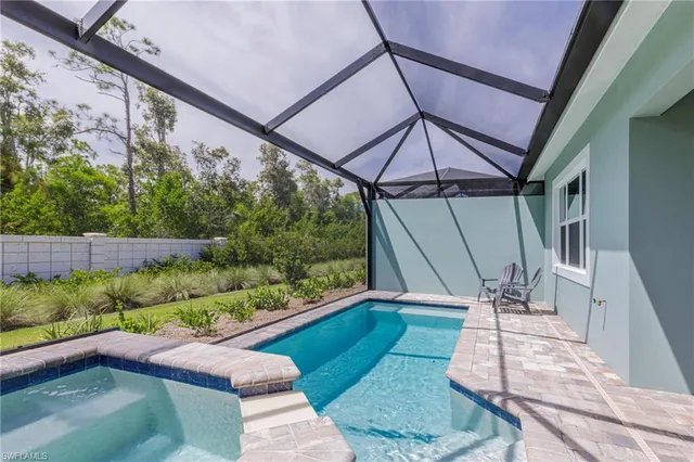 a view of yard from deck with patio