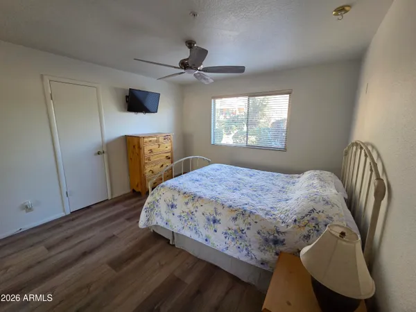 a bedroom with a bed and wooden floor